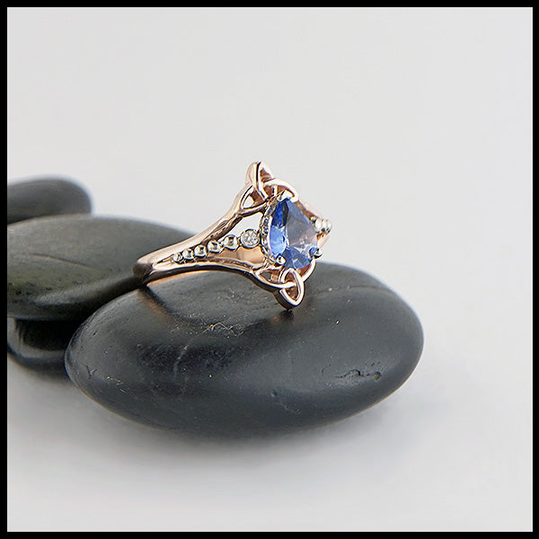 Custom 14K Rose Gold Celtic Trinity Knot ring, set with a genuine 7x5mm Blue Sapphire stone and two .04ct diamonds with 14K white gold details.