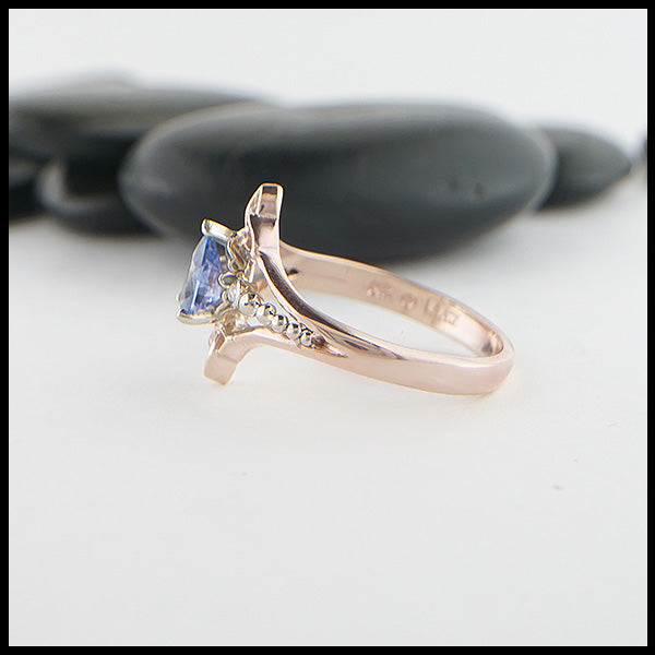 Profile view of custom 14K Rose Gold Celtic Trinity Knot ring, set with a genuine 7x5mm Blue Sapphire stone and two .04ct diamonds with 14K white gold details.