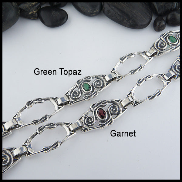 Both variations of the Celtic Spiral Link bracelet in Sterling Silver with either Green Topaz or Garnet. Made with three gemstone links & two open links.