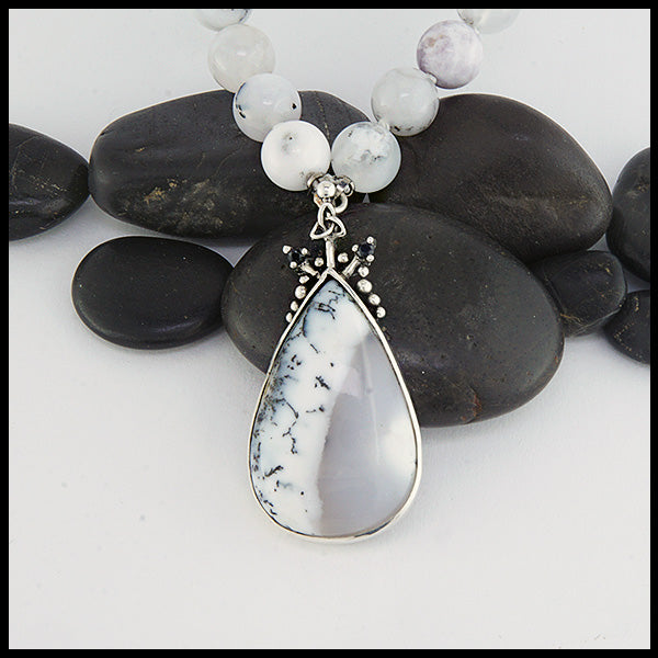 Custom beaded dendritic opal necklace with larger dendritic opal in the center and two black sapphires on either side. 