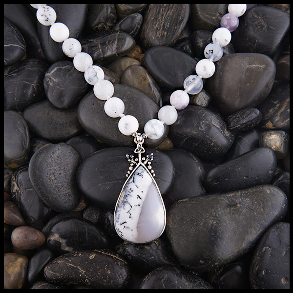 Custom beaded dendritic opal necklace with larger dendritic opal in the center and two black sapphires on either side. 