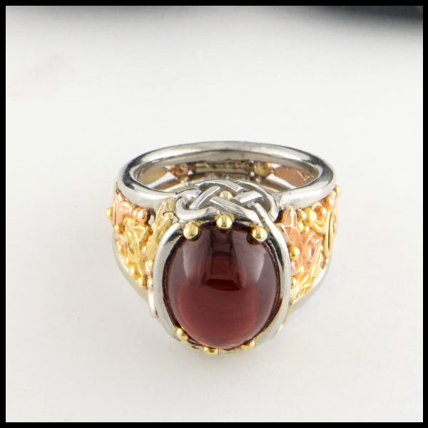 Garnet Cathedral ring in yellow, rose, and white gold