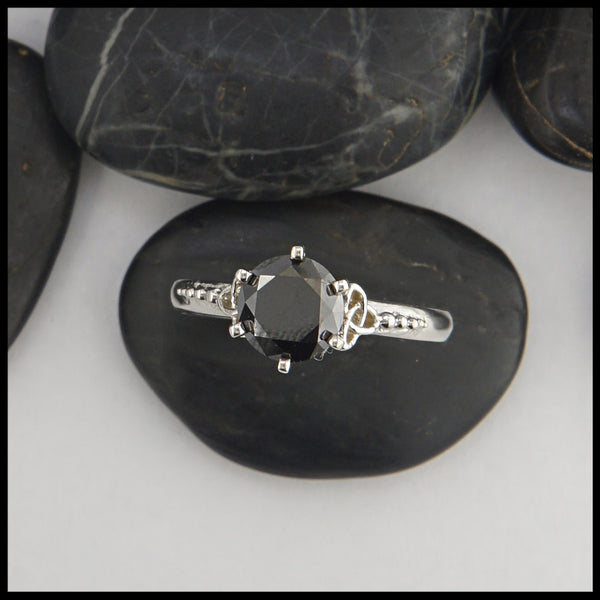 black diamond ring with trinity knot