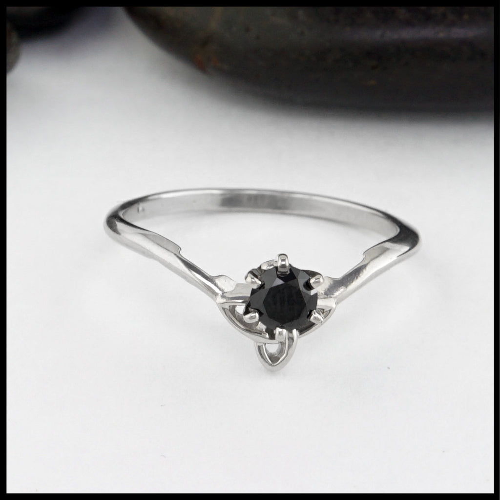 front view of ring with black diamond and trinity knot