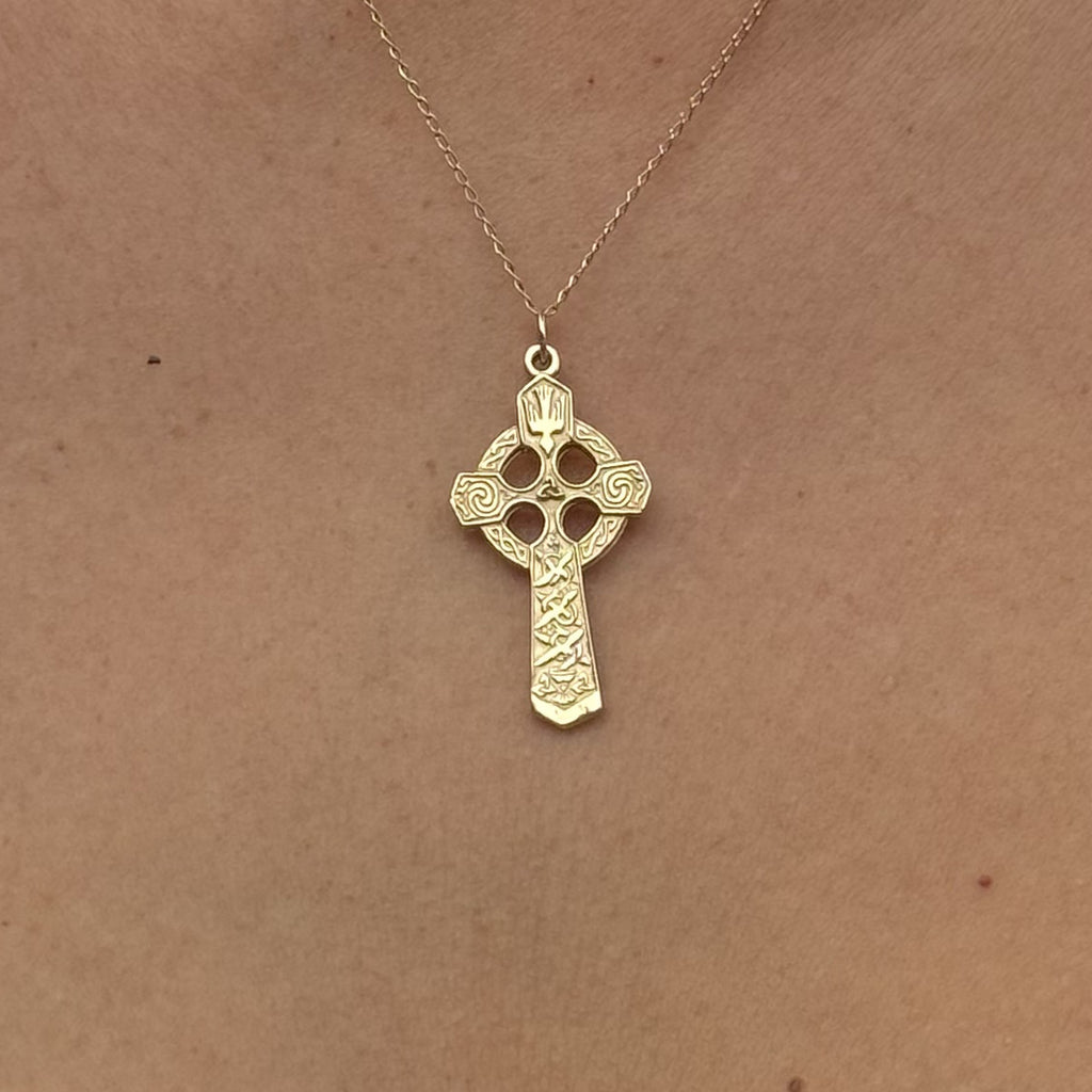 Small Celtic Trinity and Dove Cross in 14K Gold shown worn on a gold chain