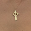 Small Celtic Trinity and Dove Cross in 14K Gold shown worn on a gold chain