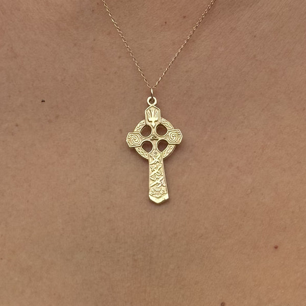 Small Celtic Trinity and Dove Cross in 14K Gold shown worn on a gold chain