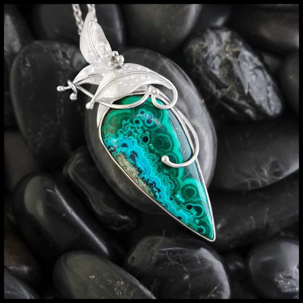 Silver Butterfly pendant with Azurite Malachite on a black stone background