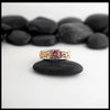 14K Rose Gold frame ring with 14K White Gold Rails,Set with a malaya garnet on a black stone with a white background