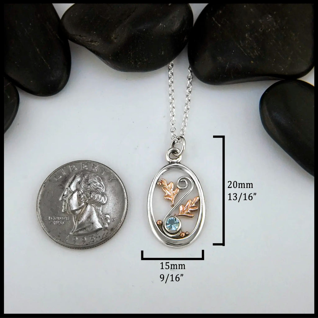 4mm Blue Topaz set in Sterling Silver  Pendant with 14K Rose Gold accents 
20mm x 15mm