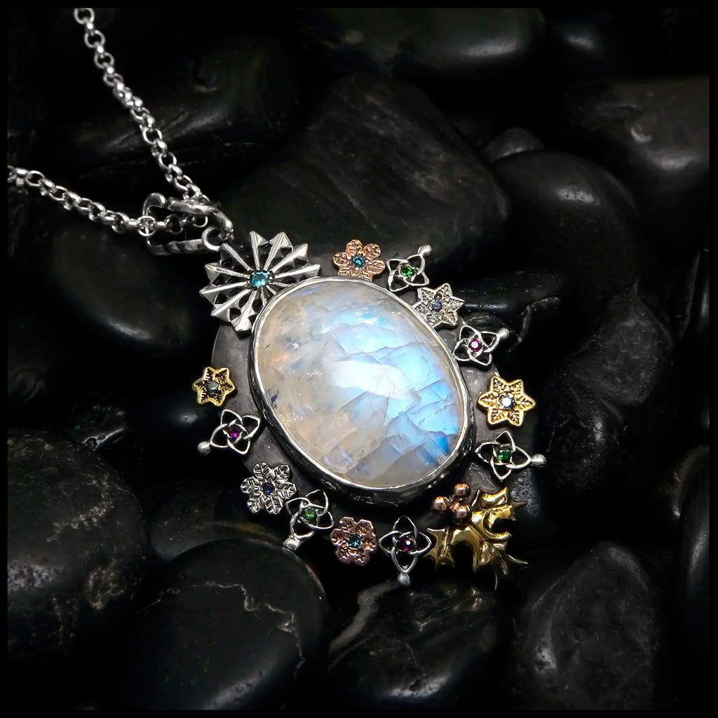 Moonstone pendant set with Blue Diamonds, Ruby, Tsavorites, and Blue Zircon in Sterling Silver and 14/18K Gold