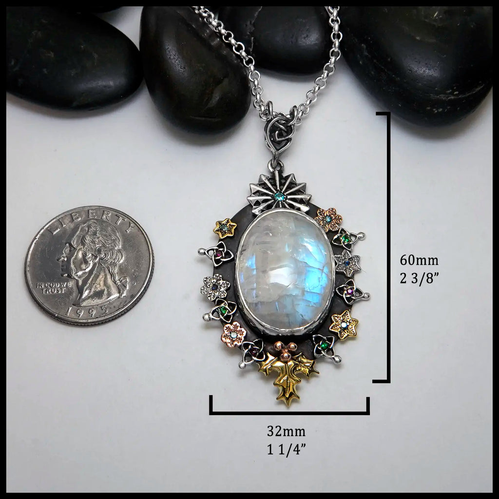 Moonstone pendant set with Blue Diamonds, Ruby, Tsavorites, and Blue Zircon in Sterling Silver and 14/18K Gold
60mm x 32mm