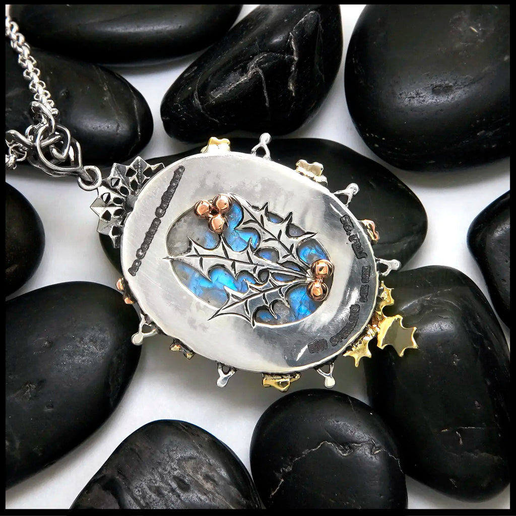 Moonstone pendant set with Blue Diamonds, Ruby, Tsavorites, and Blue Zircon in Sterling Silver and 14/18K Gold