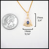 Gold pendant with a blue sapphire on a white background.
Measures at 19mm x 14mm