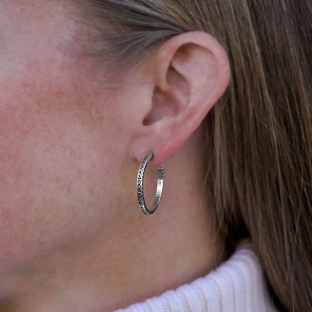 Large Josephine's Knot hoop earring in sterling silver, worn on the ear