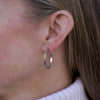 Large Josephine's Knot hoop earring in sterling silver, worn on the ear