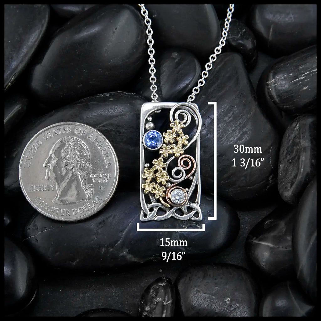 Tanzanite and Diamond Forget Me Not Pendant in Sterling Silver, 14K Rose Gold, and 18K Yellow Gold
30mm x 15mm