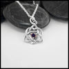 This lovely Limited Edition Trinity Knot Heart Pendant in Sterling Silver, set with 4mm Rhodolite Garnets. Includes 18" Cable Chain.