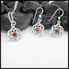 This lovely Limited Edition Set combines the Trinity Knot Heart drop earrings with its matching Pendant in Sterling Silver, both set with 4mm Deep Citrines. This set includes 18" Cable Chain.