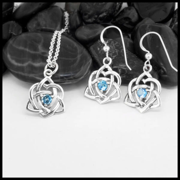 Sterling Silver Trinity Heart Pendant and matching Earrings set with a 4mm Blue Topaz. Includes an 18" Cable Chain. This is a Limited Edition Set.