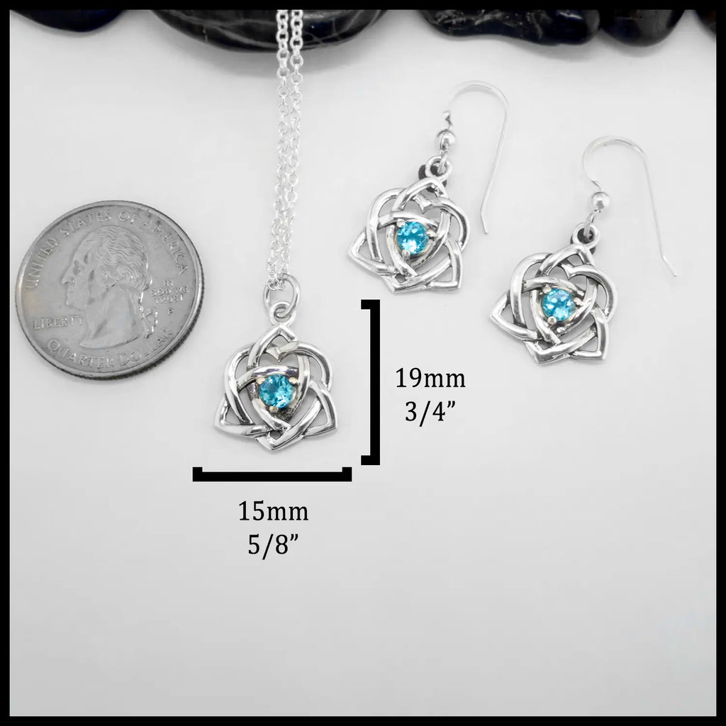 Sterling Silver Trinity Heart Pendant and matching Earrings set with a 4mm Blue Topaz. Includes an 18" Cable Chain. The measurements are: 19mm or 3/4" Tall and 15mm or 5/8" Wide