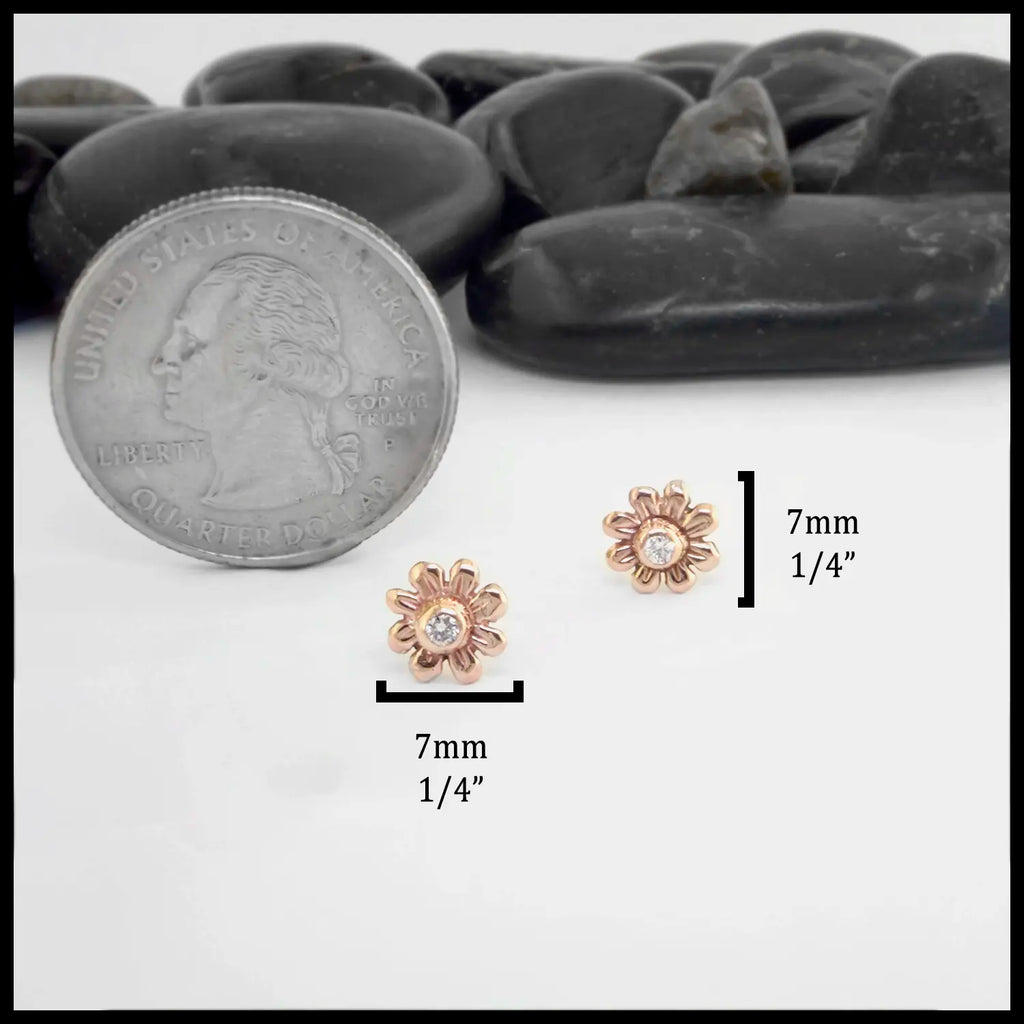 Small rose gold flower earrings next to a quarter for scale, with measurement labels on a white background. The measurements are: 7mm or 1/4" total.