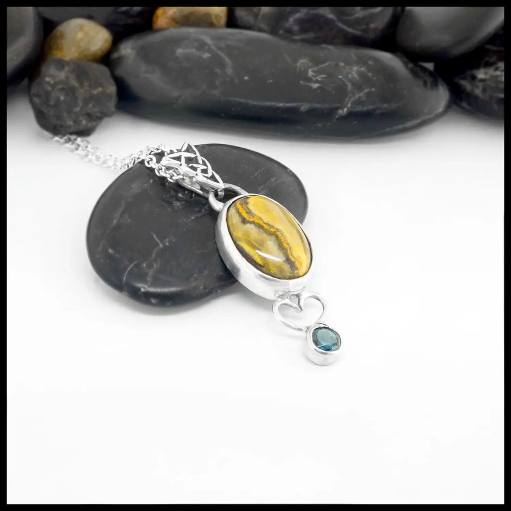 Necklace with a pendant featuring Bumblebee Jasper and Evergreen Topaz on a white background