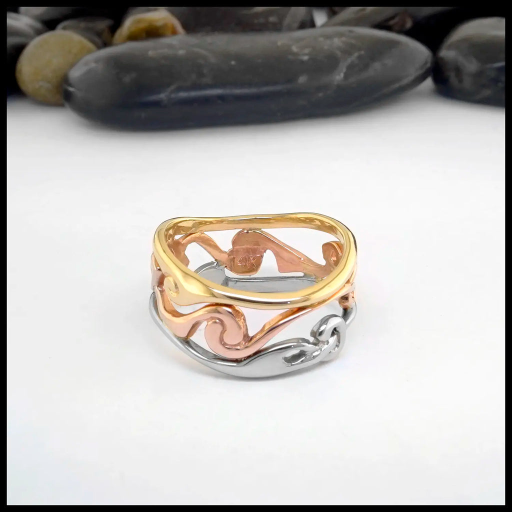 Tri-color ring with yellow gold, rose gold, and white gold tones on a white background.