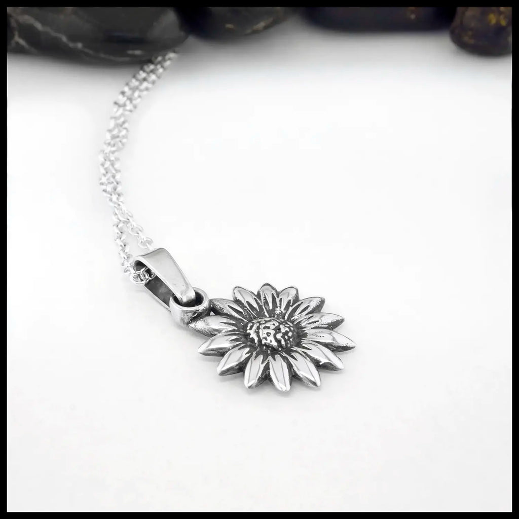 Silver sunflower pendant necklace on a white background