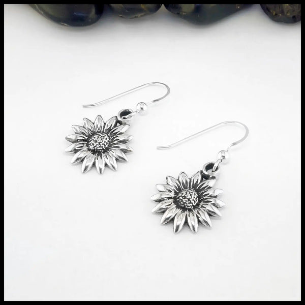 Silver sunflower earrings on a white background