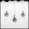 Silver sunflower pendant necklace and earrings on a white background