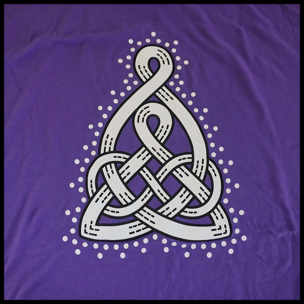 White Celtic Mother's knot design on a purple t-shirt.