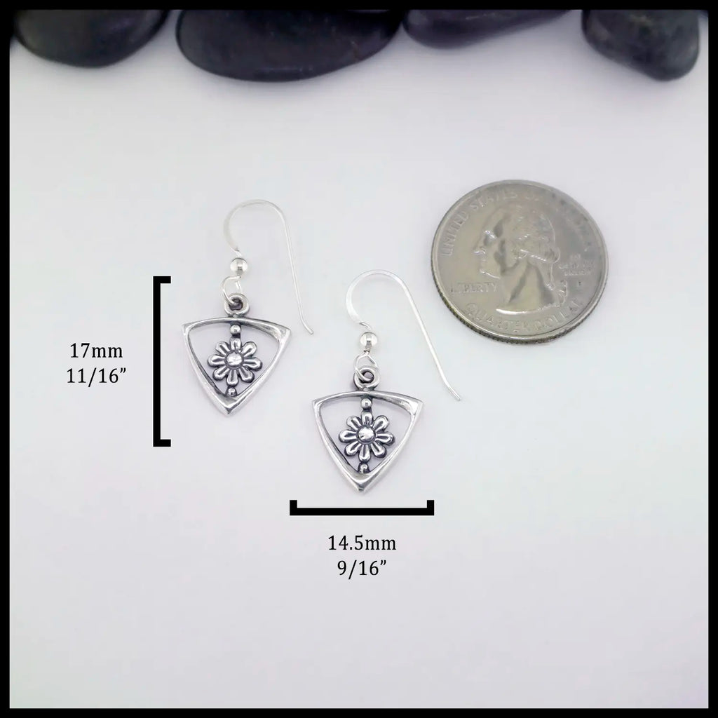 Silver triangle frame earrings with daisy designs on a white background with measurements and a coin for scale. Measurements: 17mm or 11/16" Tall and 14.5mm or 9/16" Wide.