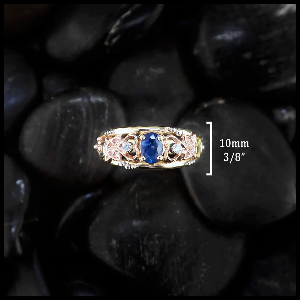 10mm face frame ring. Gold custom frame ring with rose gold, white gold, and yellow gold set with two diamonds and an oval blue sapphire