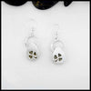 Silver drop earrings with clover designs on a white background