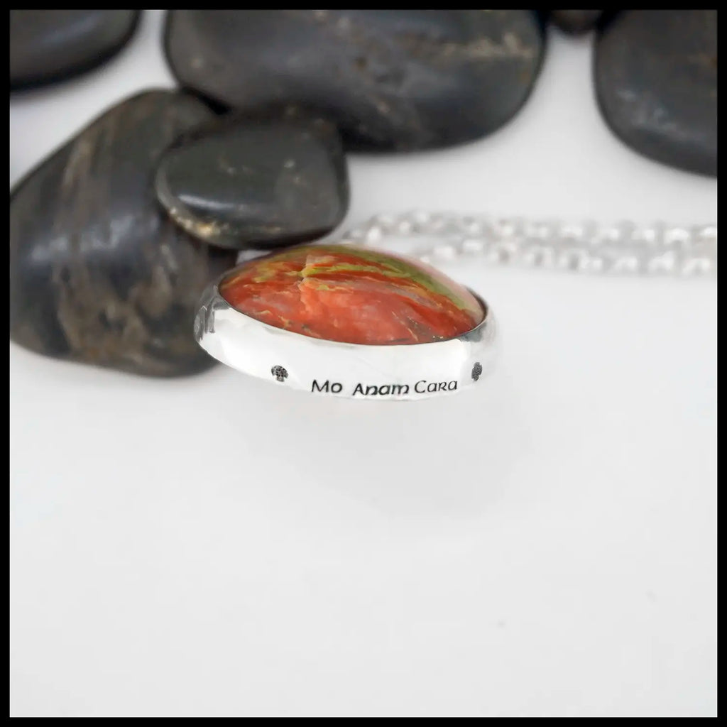 Sterling silver bezel set pendant with deep red Iona bloodstone with green veining throughout the stone. Engraved with "Mo Anam Cara' on the bottom.