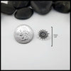 Silver flower-shaped Sterling Silver Pin on a white surface with black stones in the background. Measurements are 16mm or 5/8" circumference. 
