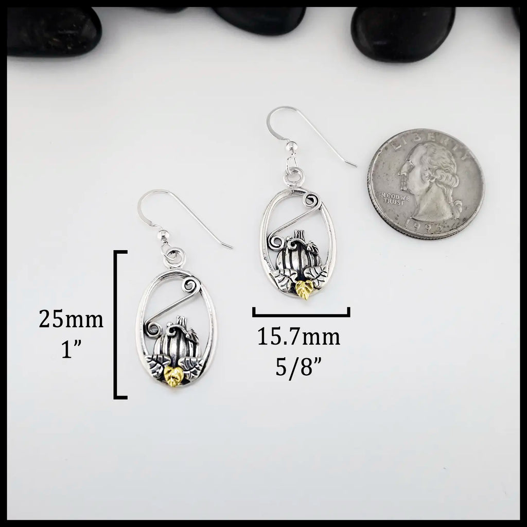 Silver pumpkin frame earrings with measurements and a quarter for scale on a white background ( 25mm or 1" Tall and 15.7mm or 5/8" wide)