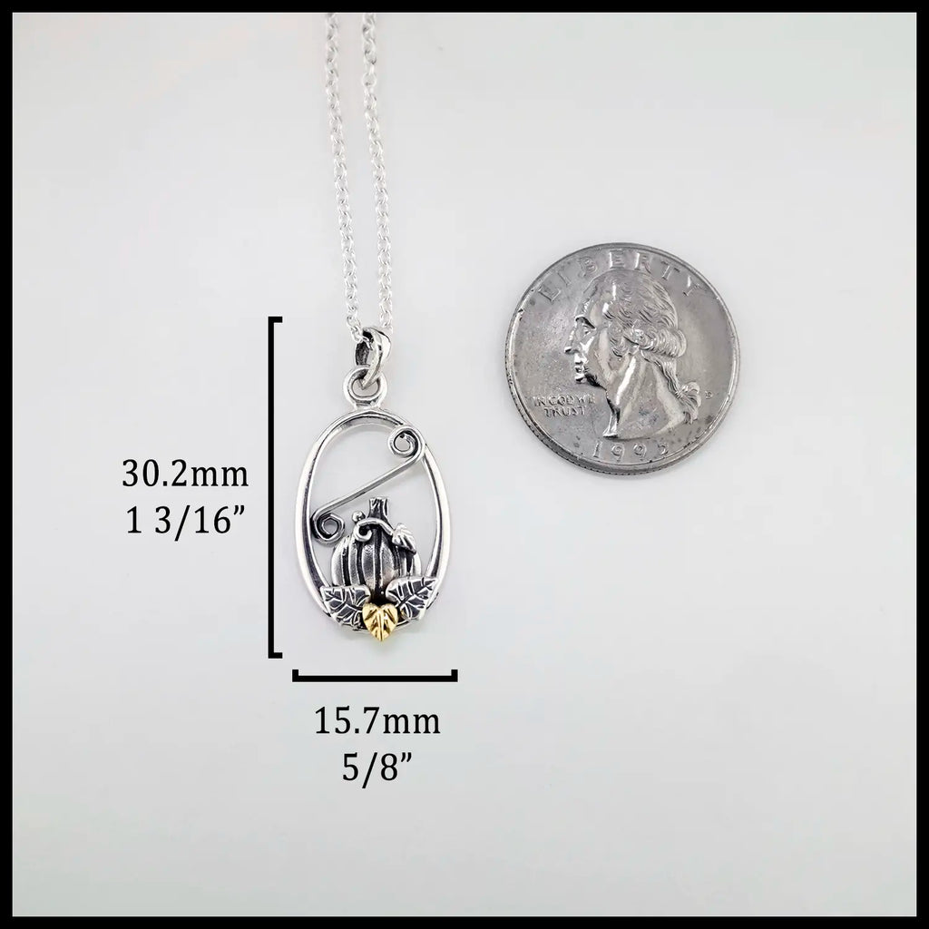 Silver pendant with measurements and a quarter for scale on a white background (30.2mm or 1 3/16" Tall and 15.7mm or 5/8' Wide)