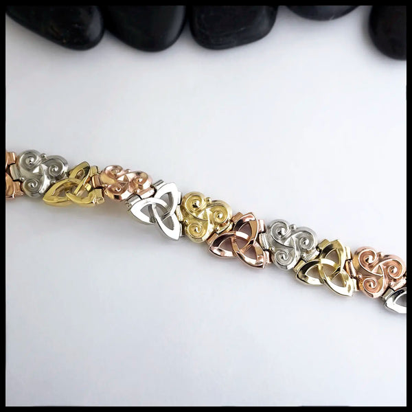 Alternating Link bracelet with tri-color 14k gold trinity and triskele knots.