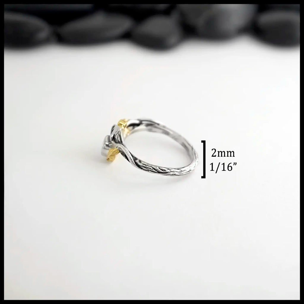 Silver Ruby & Diamond ring with a yellow gold leaf on a white background. Measurements: 2mm or 1/16" band
