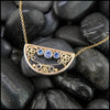 14K Yellow Gold frame pendant on an attached chain, featuring ceylon blue sapphires and 18K gold details.