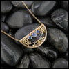 14K Yellow Gold frame pendant on an attached chain, featuring ceylon blue sapphires and 18K gold details.