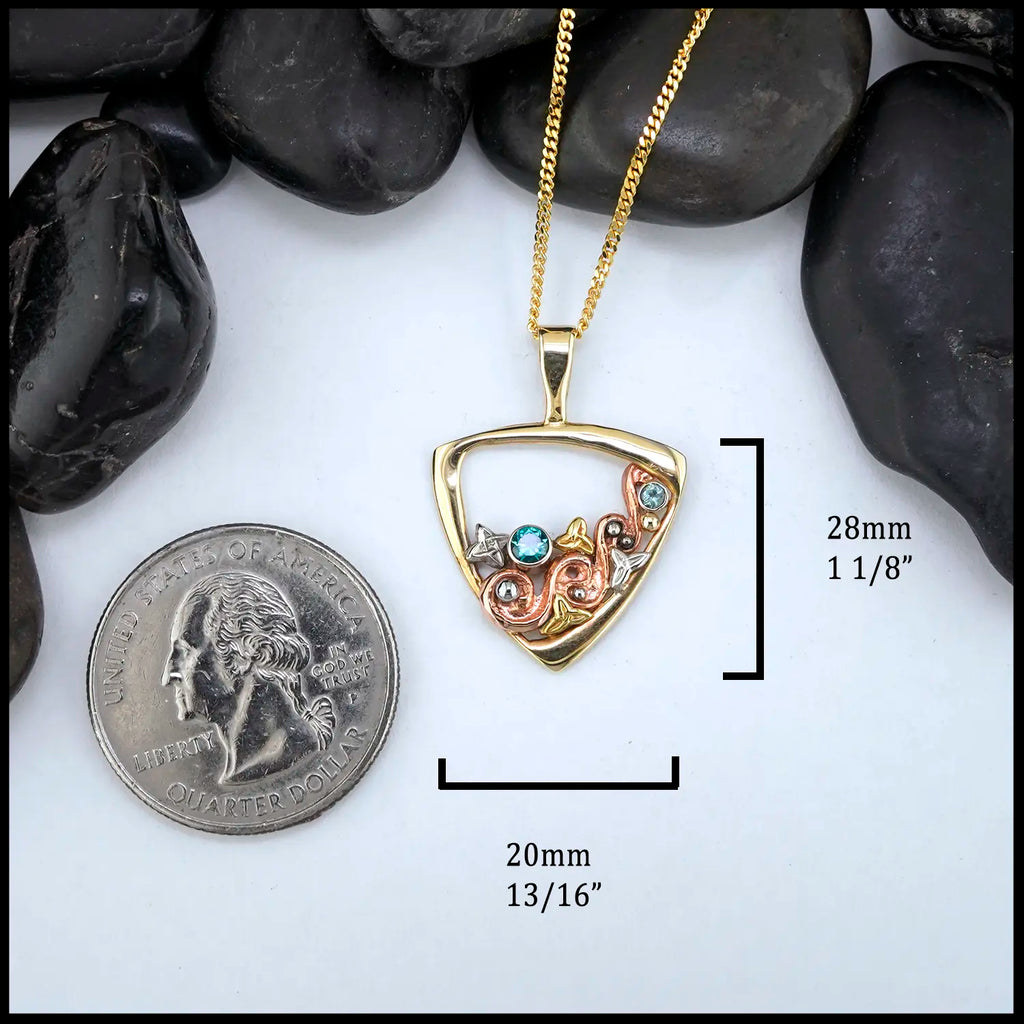 Gold Celtic swirl pendant with rose, white and yellow gold accents, set with a 3mm Tsavorite, and a 2mm Mint Garnet
Measures at 28mm x 20mm