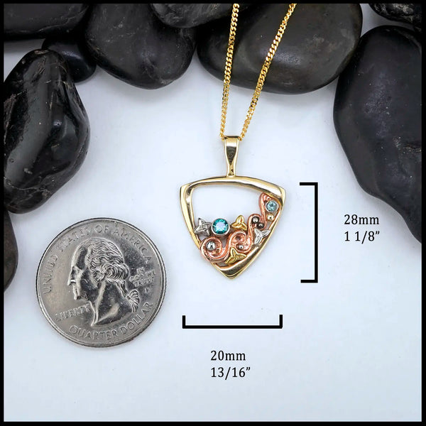 Gold Celtic swirl pendant with rose, white and yellow gold accents, set with a 3mm Tsavorite, and a 2mm Mint Garnet
Measures at 28mm x 20mm