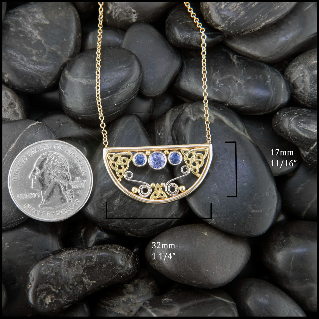 14K Yellow Gold frame pendant on an attached chain, featuring ceylon blue sapphires and 18K gold details. Measures at 17mx32mm