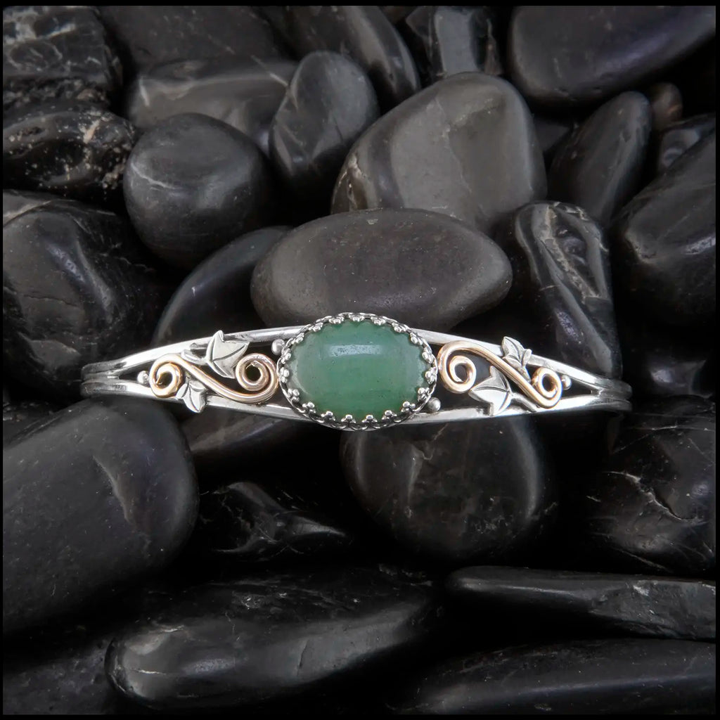Aventurine cuff bracelet set in a Sterling Silver Frame, with sterling silver ivy leaves and beads and 14K yellow gold-filled swirls.