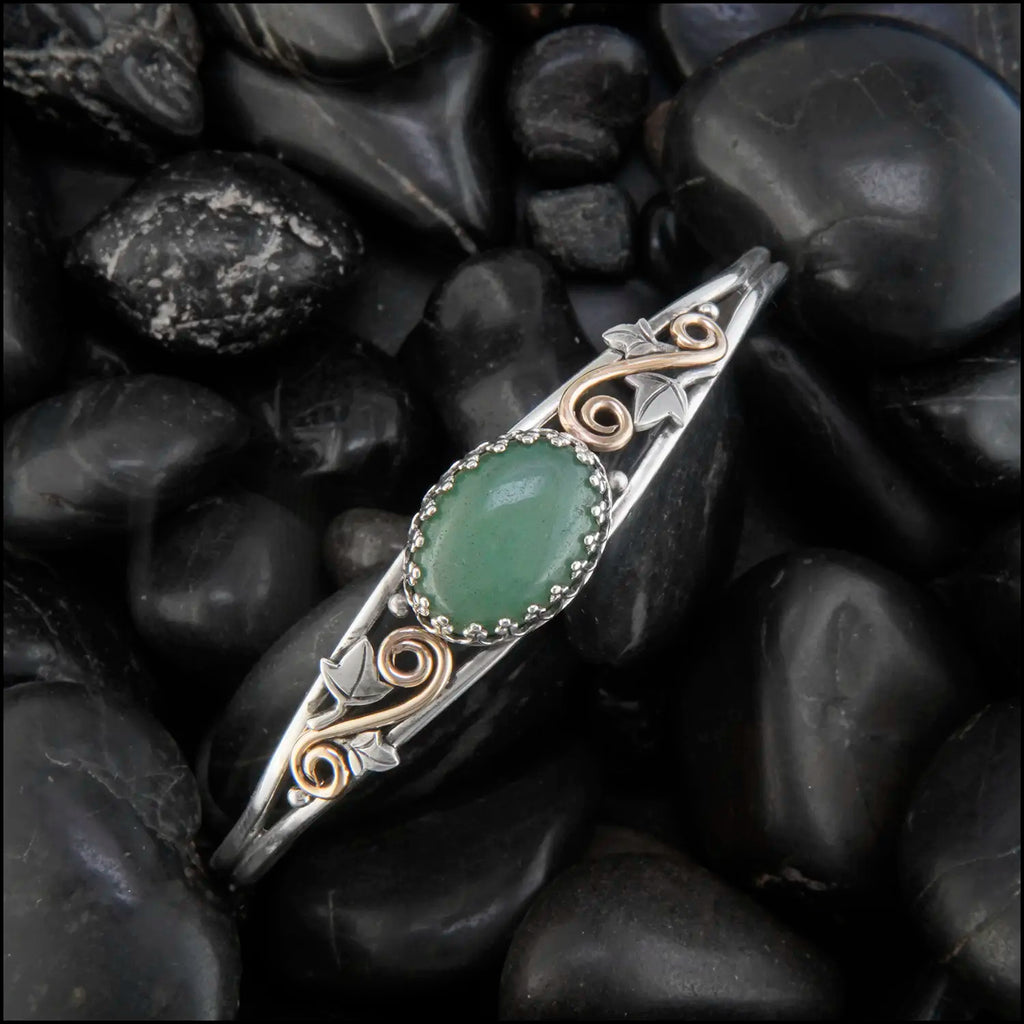 Aventurine cuff bracelet set in a Sterling Silver Frame, with sterling silver ivy leaves and beads and 14K yellow gold-filled swirls.