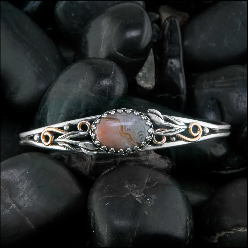 Crazy Lace Agate cuff bracelet set in a Sterling Silver Frame, with sterling silver tulips and beads, with 14K rose gold-filled swirls.