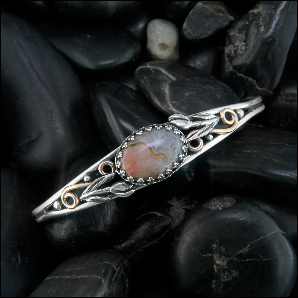 Crazy Lace Agate cuff bracelet set in a Sterling Silver Frame, with sterling silver tulips and beads, with 14K rose gold-filled swirls.